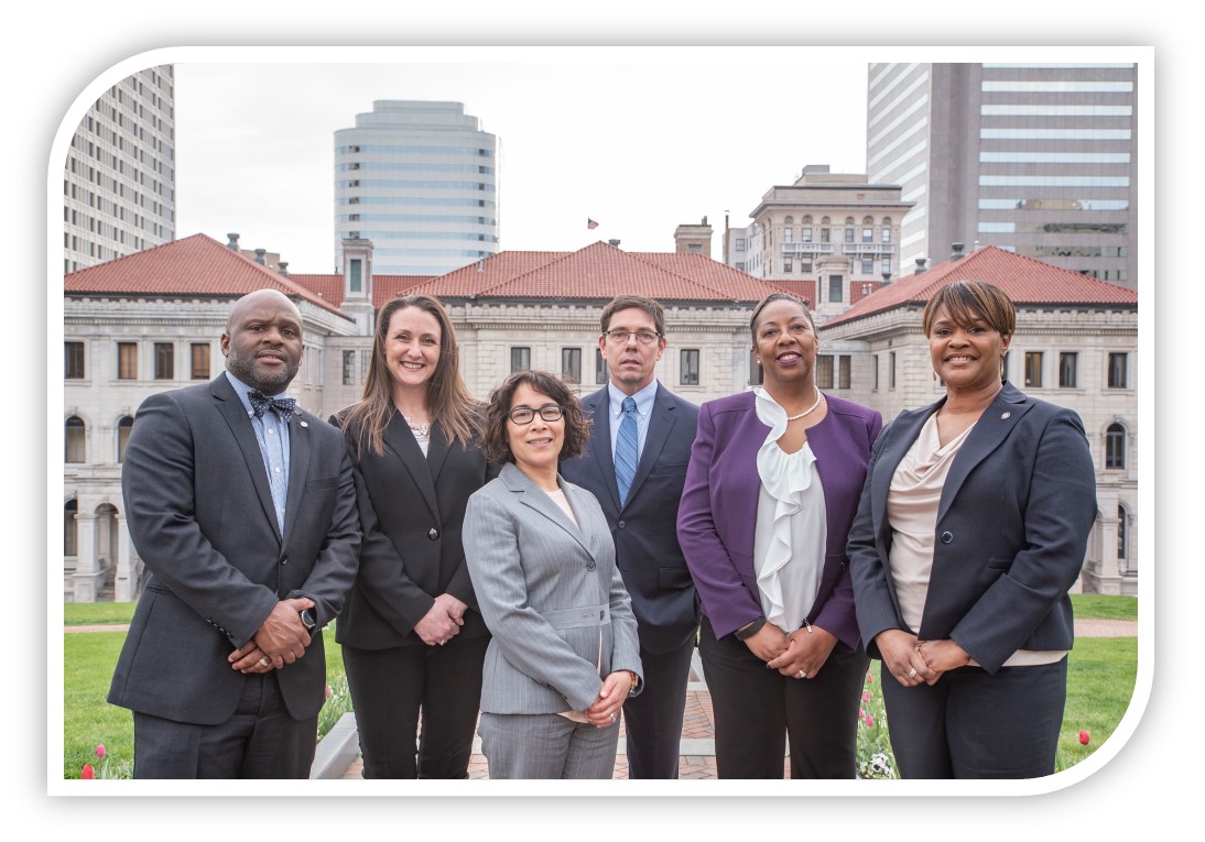 Diverse group of Alumni posing in Downtown Richmond with the General Assembly in the background